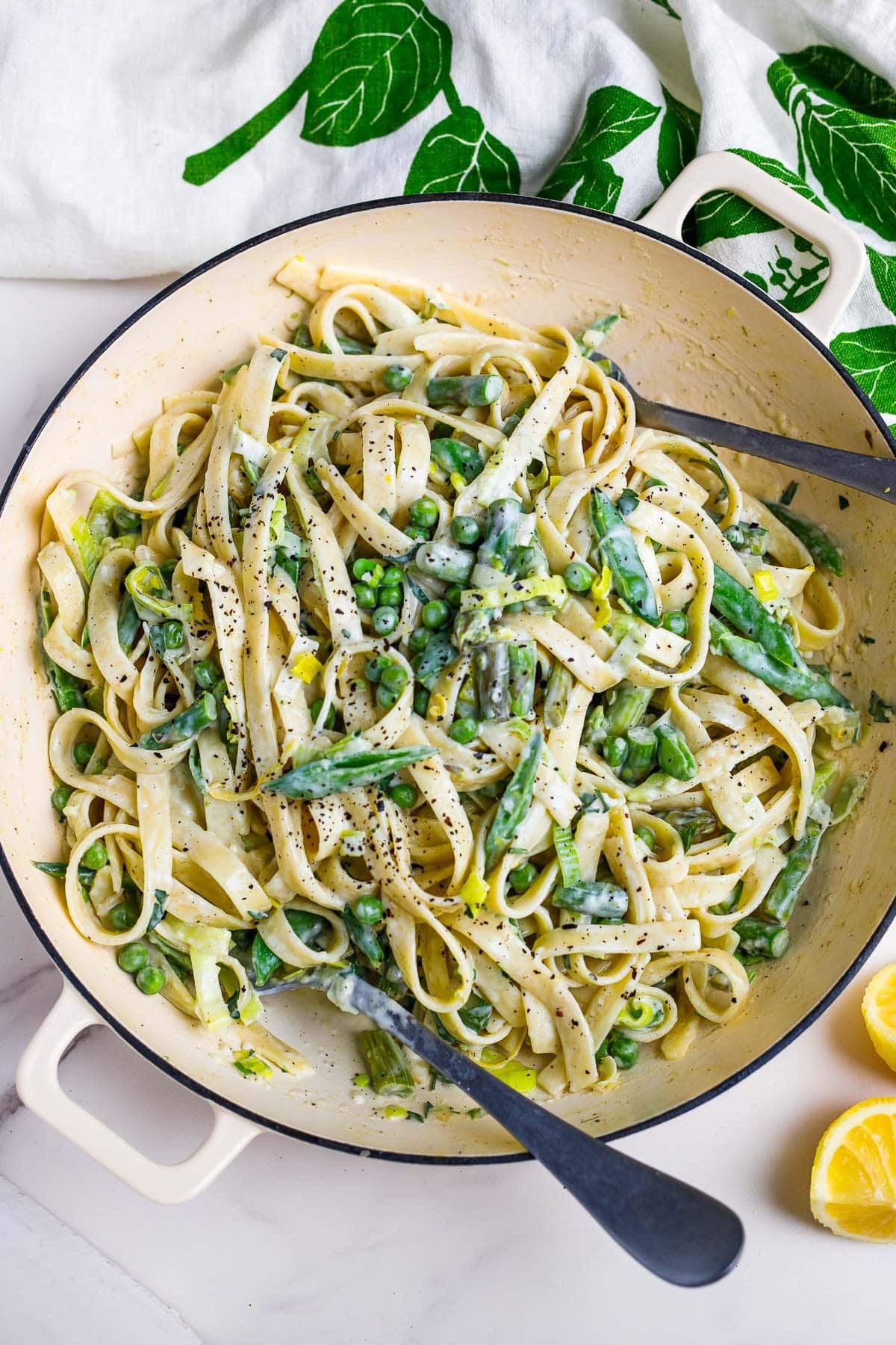 This light and creamy pasta primavera makes the perfect spring dinner! Tender pasta and spring vegetables are kissed with a light cream sauce infused with lemon and herbs. 