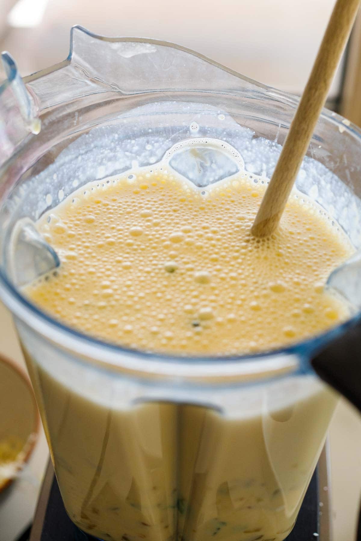 blended egg mixture in blender with wood utensil to stir in cheese and herbs. 