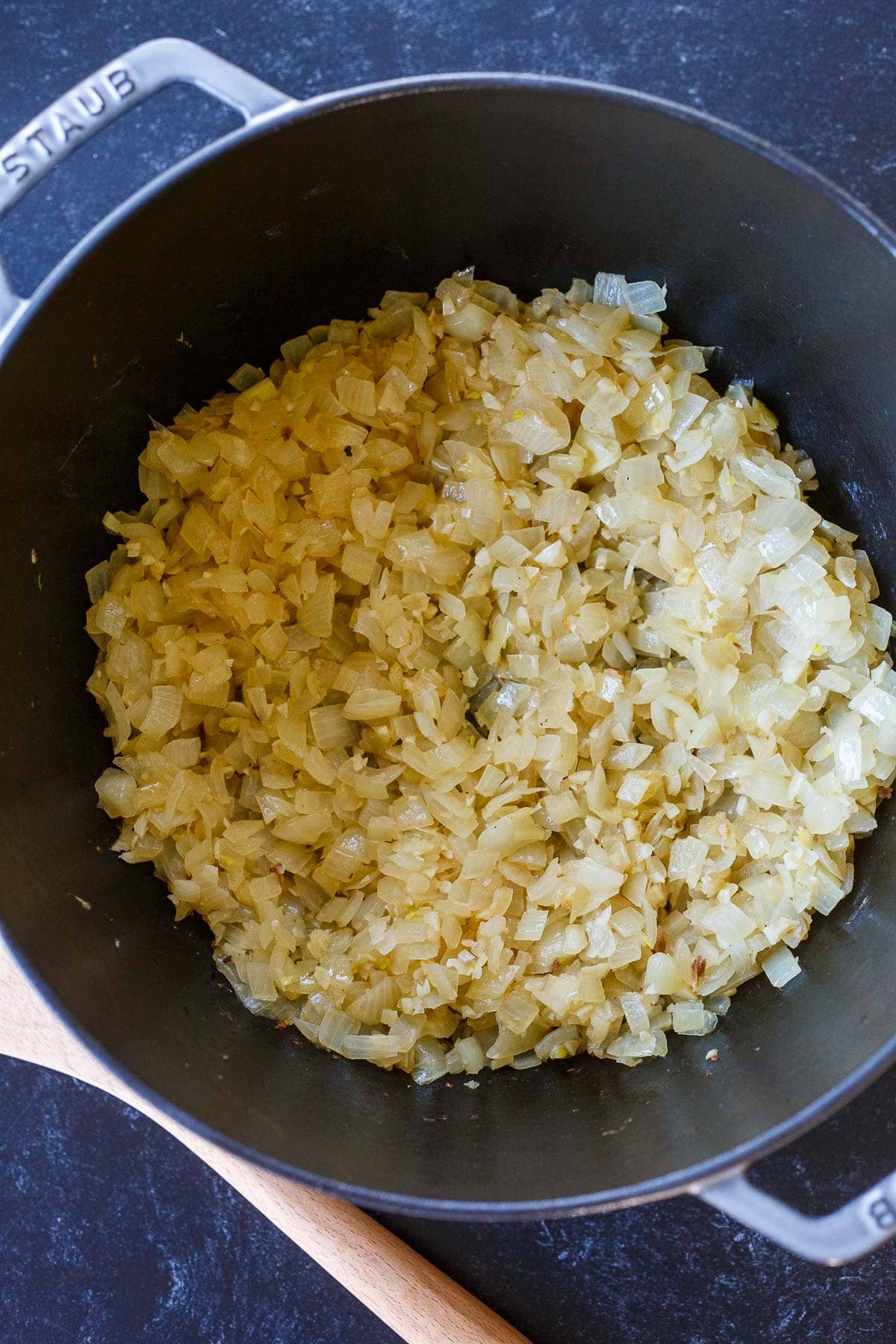 Dutch oven with sautéed onion and garlic.