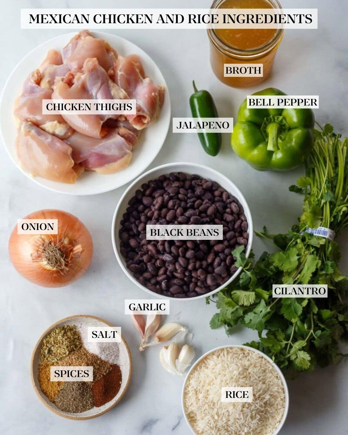 ingredients for Mexican chicken skillet - jar of broth, plate of chicken thighs, jalapeño, green bell pepper, cilantro bunch, bowl of black beans, onion, garlic cloves, small dish of spices, small bowl of rice. 