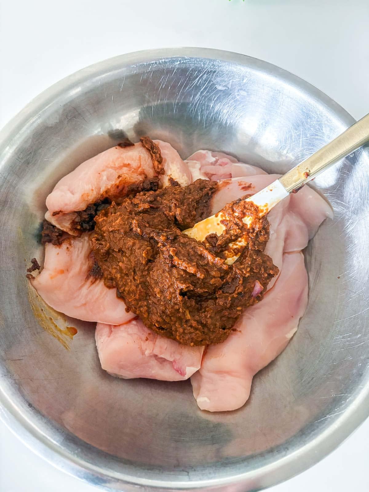 chipotle chicken marinade on top of the chicken. 