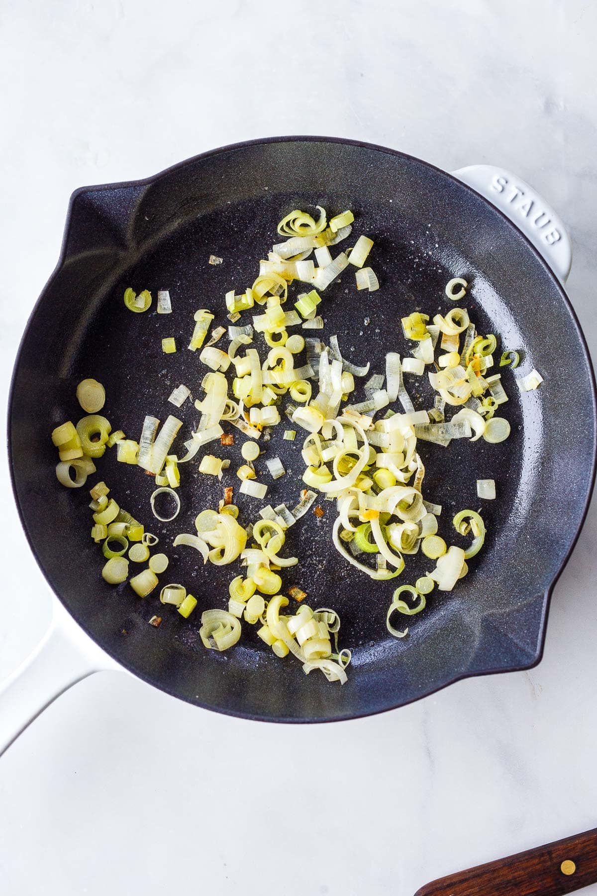 sautéed leeks in a pan.