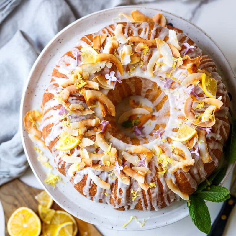 A delicious, easy, one-bowl Lemon Bundt Cake recipe made with coconut milk, drizzled with a tangy lemon glaze. Vegan with a video.
