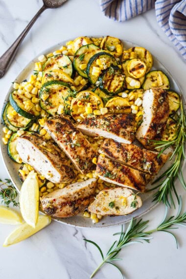 Mediterranean Grilled Chicken is an easy, flavor-packed summer dinner made with juicy herb-marinated chicken breasts, charred zucchini, and sweet grilled corn. Bright lemon, garlic, and fresh herbs infuse every bite! Gluten-free.