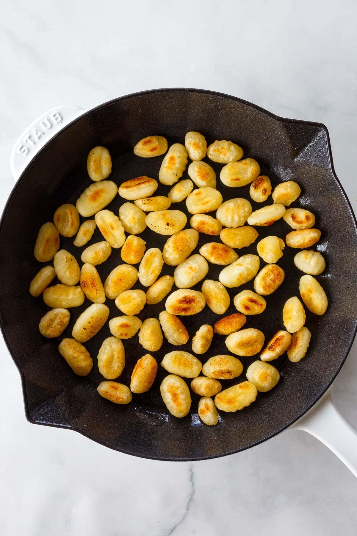 gnocchi searing in a skillet.