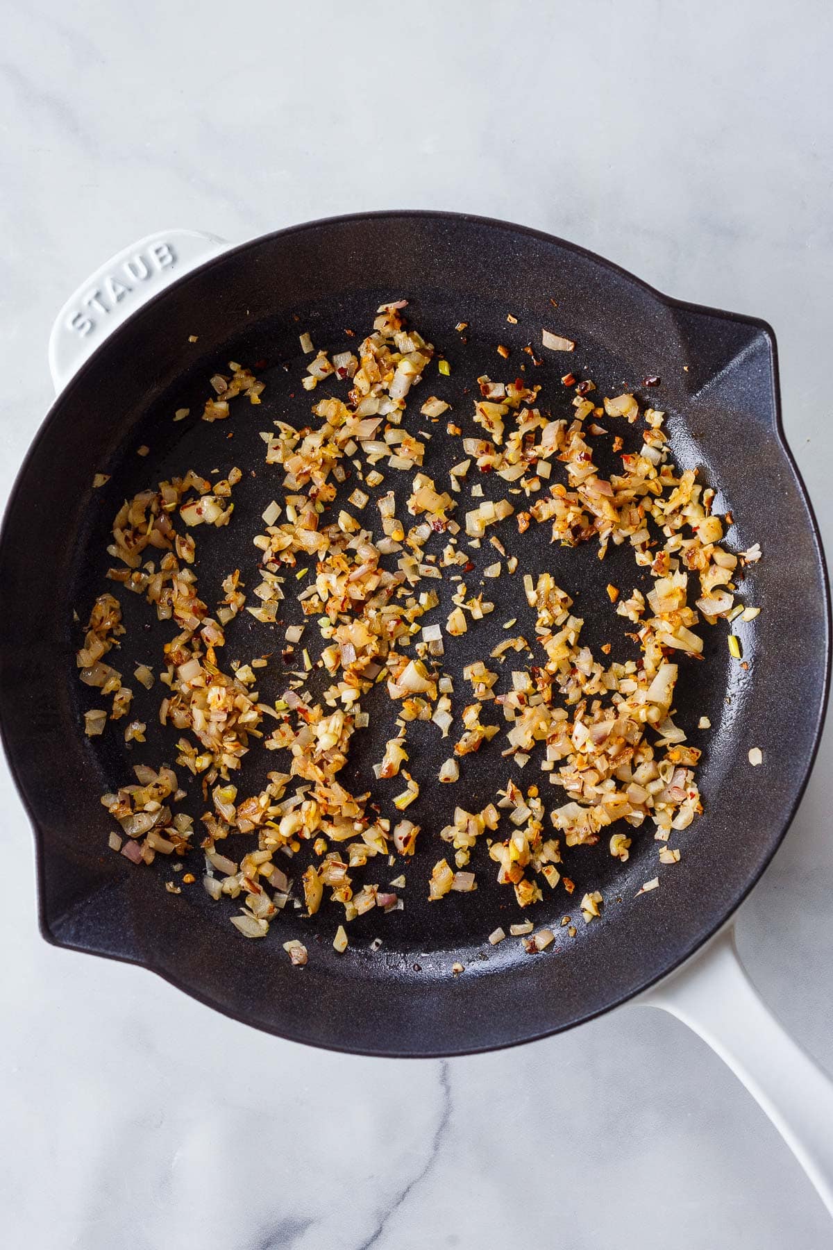 skillet with sautéed shallots and garlic.