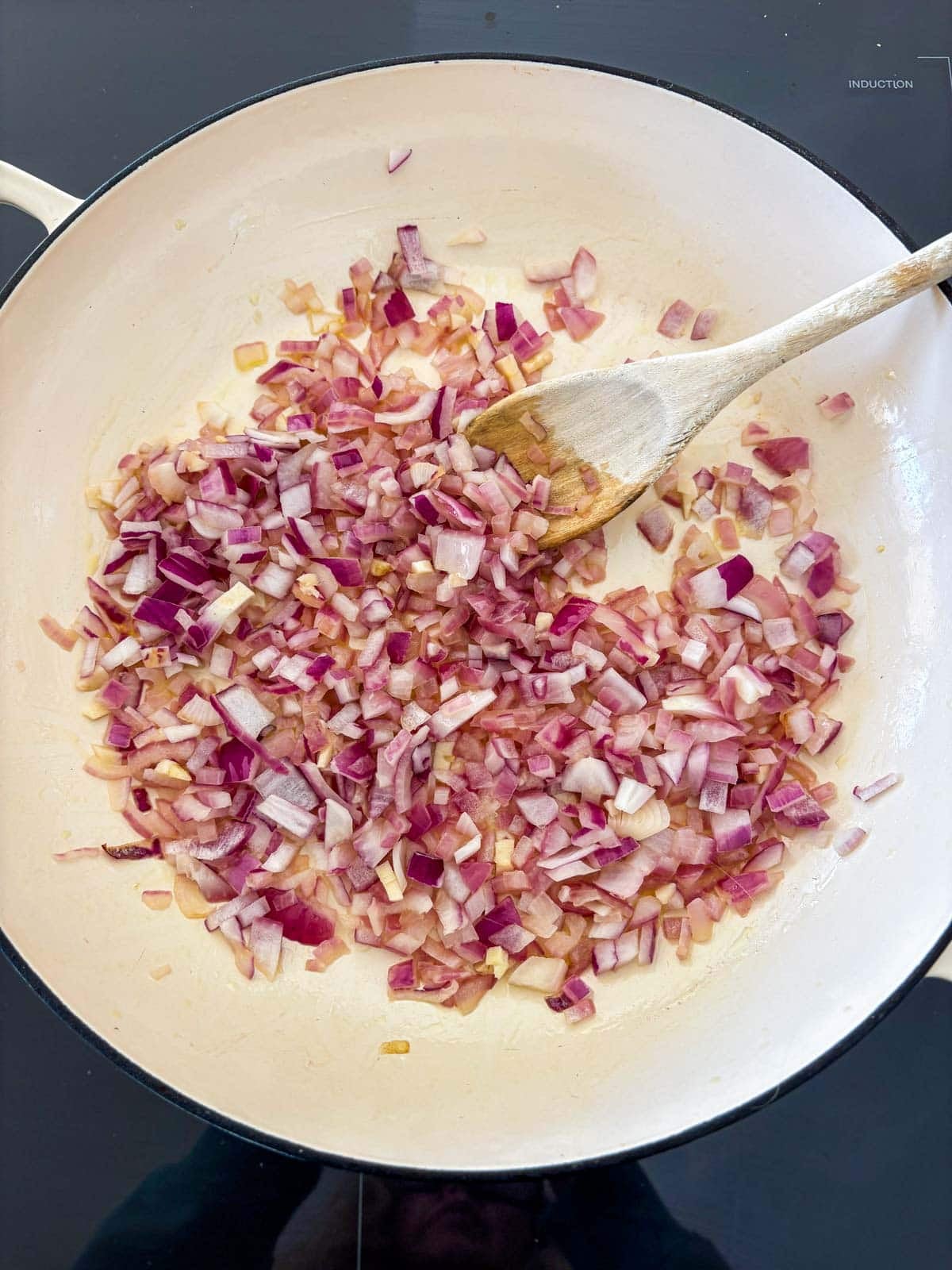 sautéed onions and garlic in a braiser.