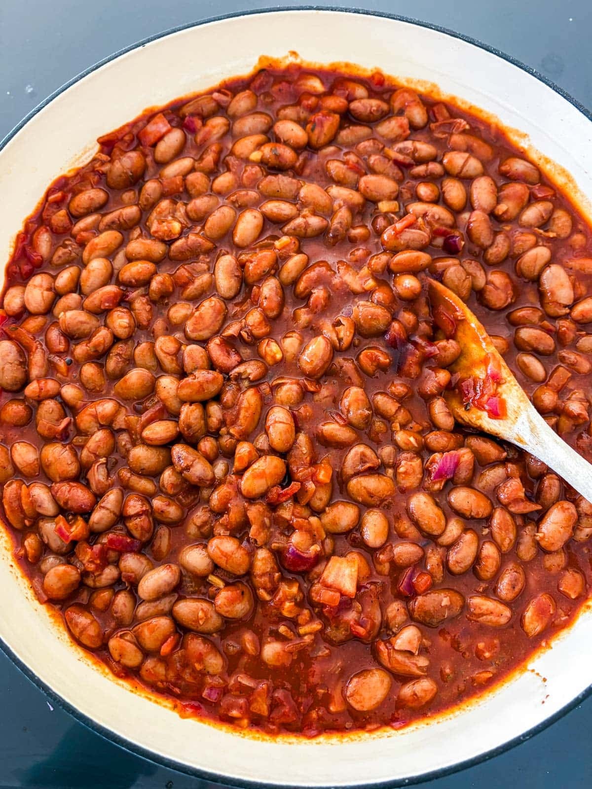 Stirring in the beans.