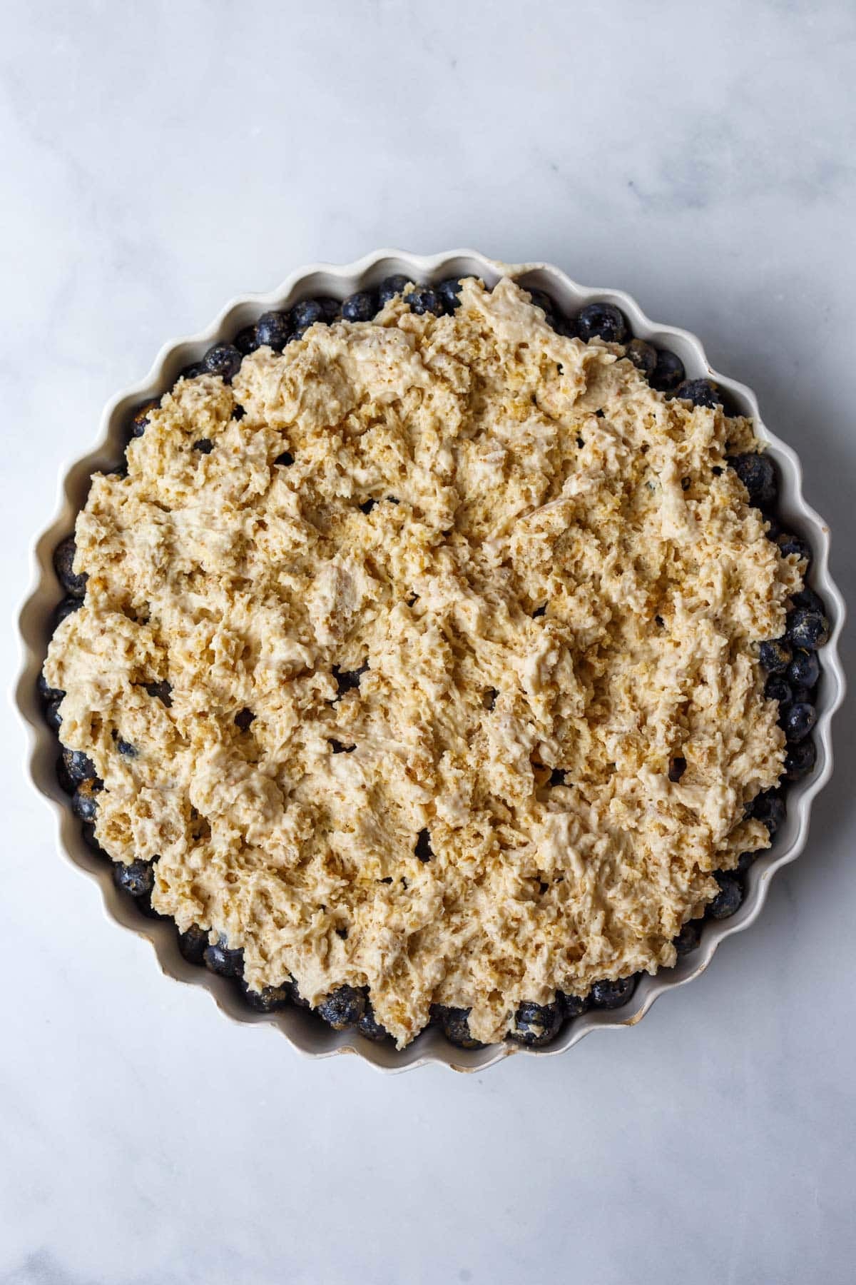 assembled blueberry cobbler with biscuit dough on top.