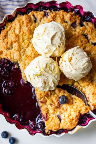 Fresh blueberry cobbler with a hint of lemon and a golden brown butter biscuit topping — crisp, lightly sweetened, and bursting with summer flavor. Easy and delicious.