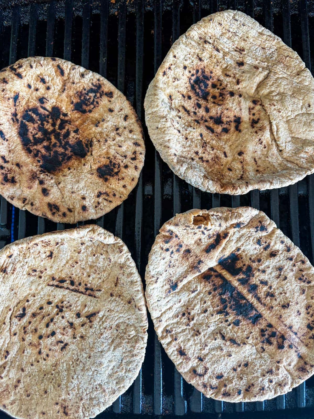 pita bread rounds on the grill.
