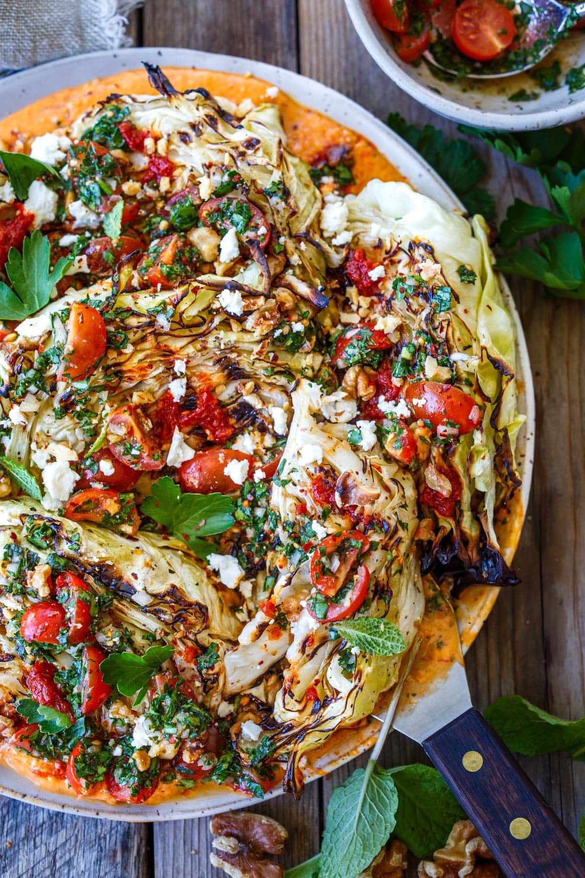 grilled cabbage topped with tomato herb gremolata and crumbled feta.