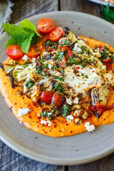 Grilled cabbage on a bed of creamy white bean puree.