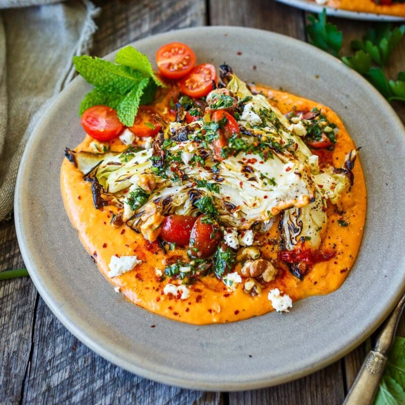 Grilled cabbage on a bed of creamy white bean puree.