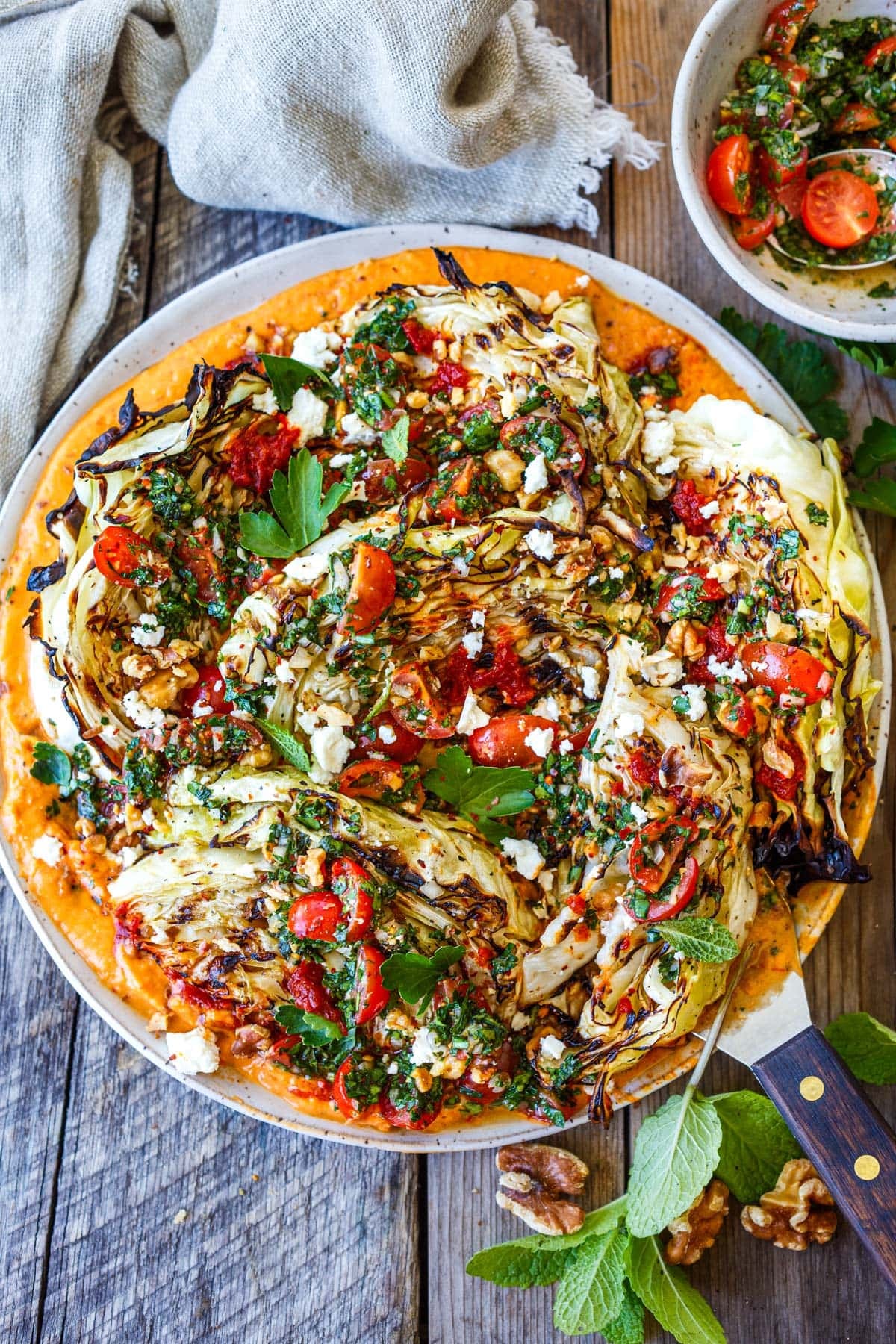 grilled cabbage over harissa white bean puree, topped with tomato gremolata and feta. 