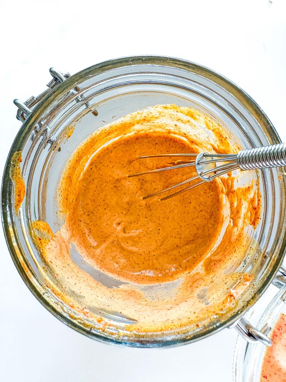 jar of chipotle mayo with a whisk.