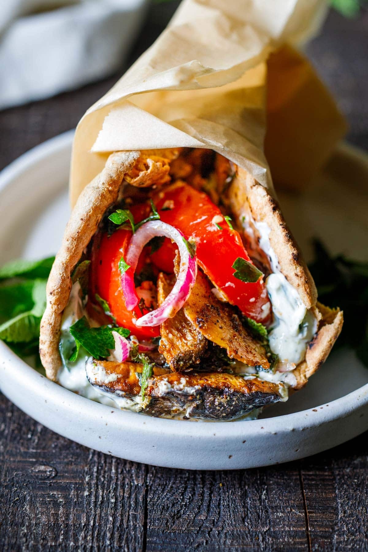 A souvlaki pita sandwich wrapped in parchment.
