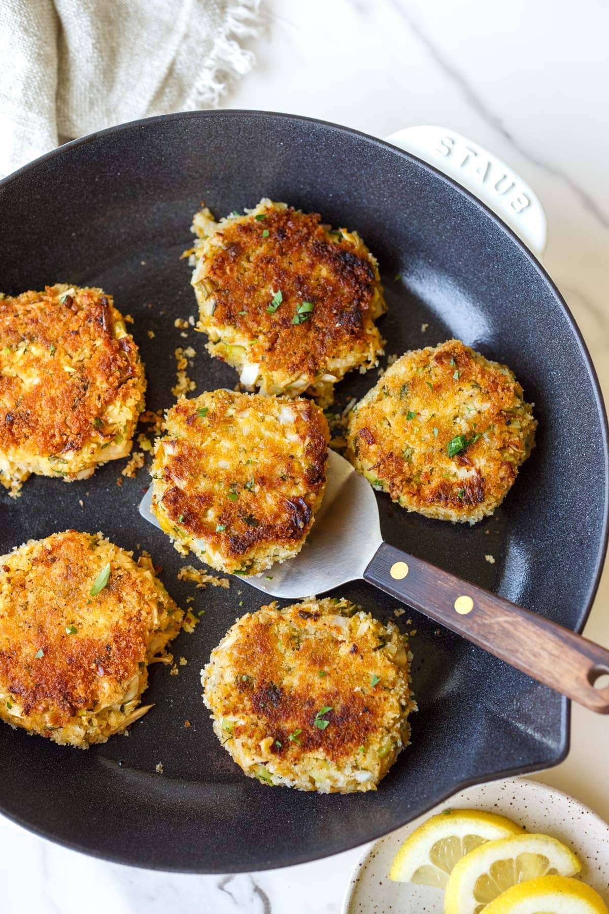 vegetarian crab cakes frying in a pan. 