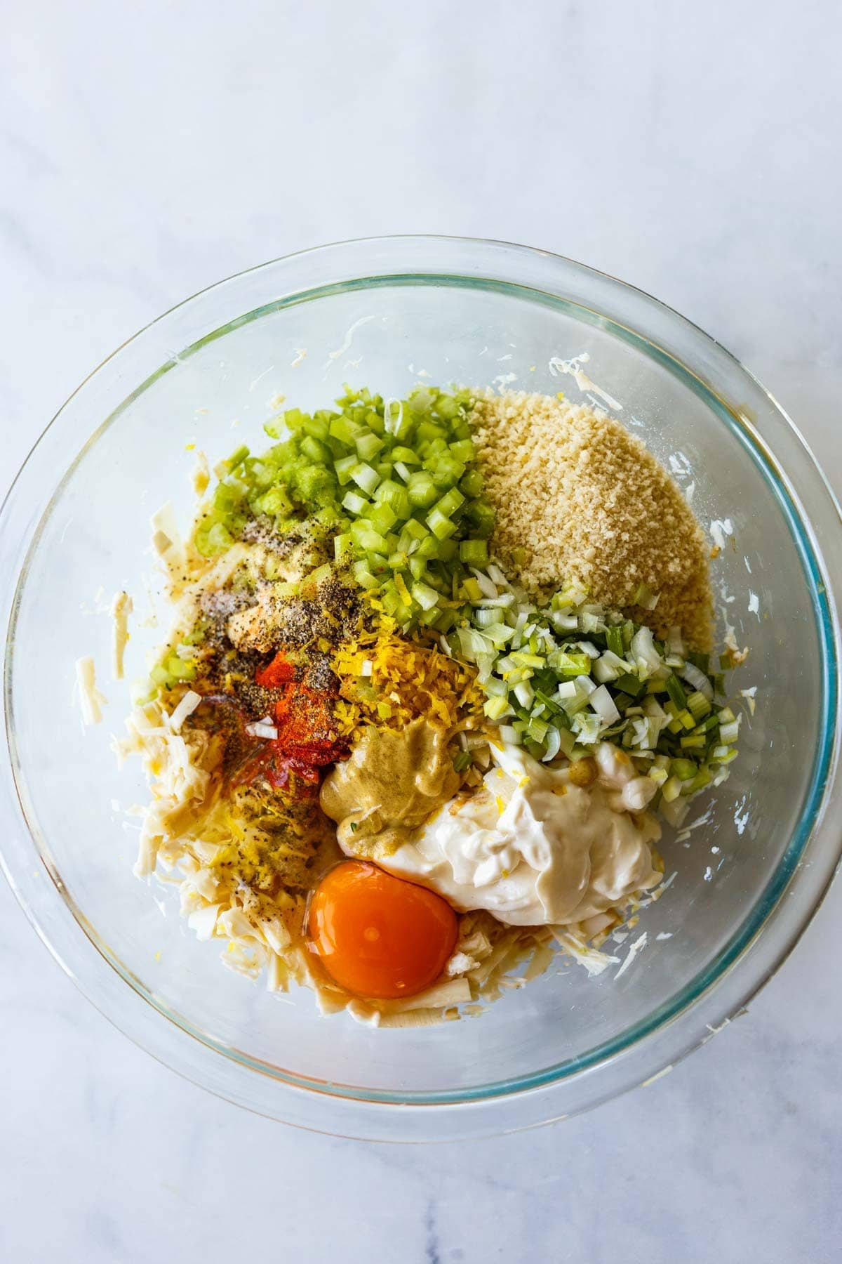 glass mixing bowl with ingredients to make vegetarian crab cakes.