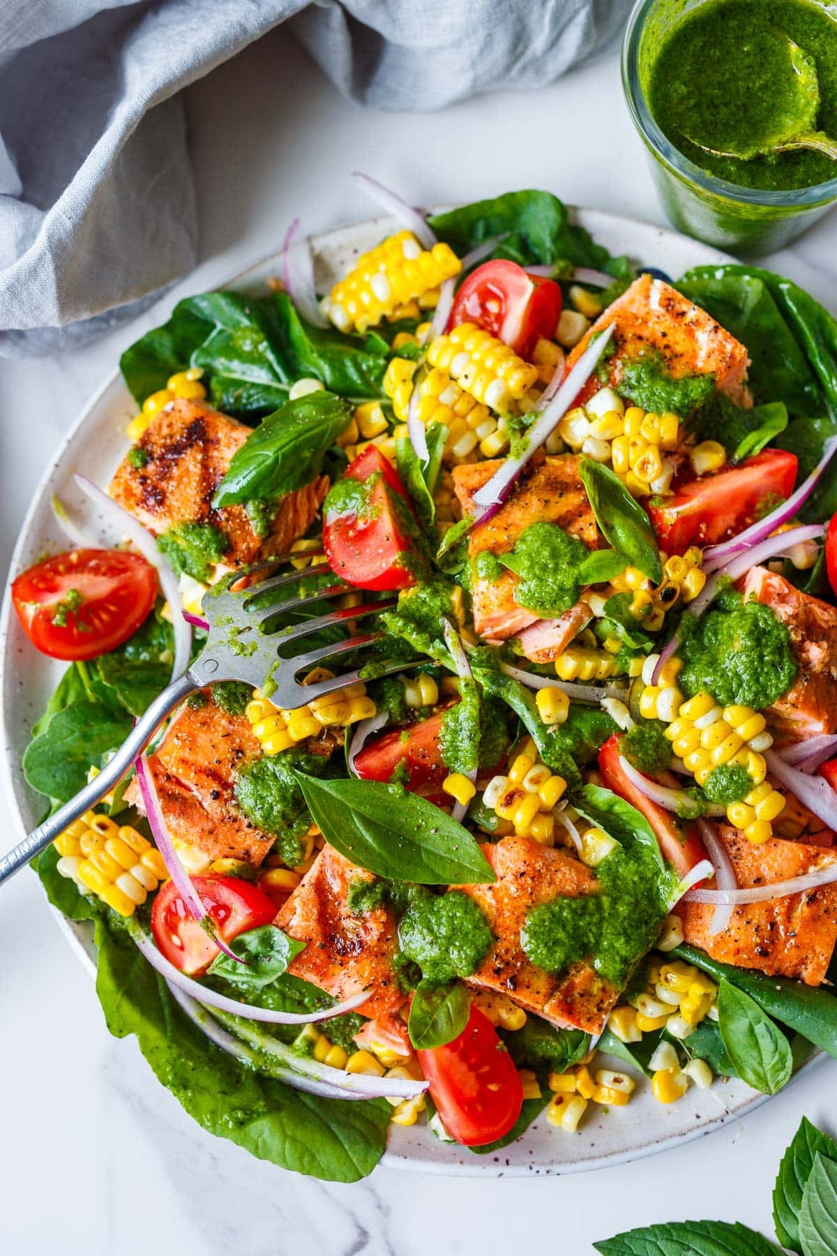 salmon salad with tomato, corn, red onion, and basil with basil vinaigrette. 