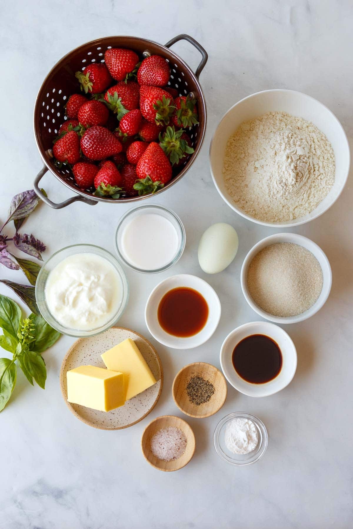 ingredients for strawberry cobbler - strawberries, flour, sugar, egg, milk, yogurt, maple syrup, balsamic, butter, pepper, salt, baking powder.