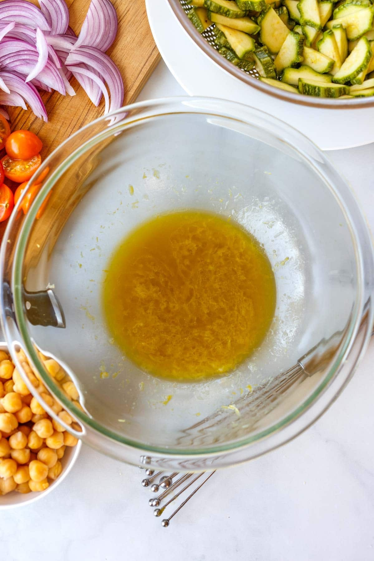 lemon Dijon vinaigrette for zucchini salad in a glass mixing bowl.