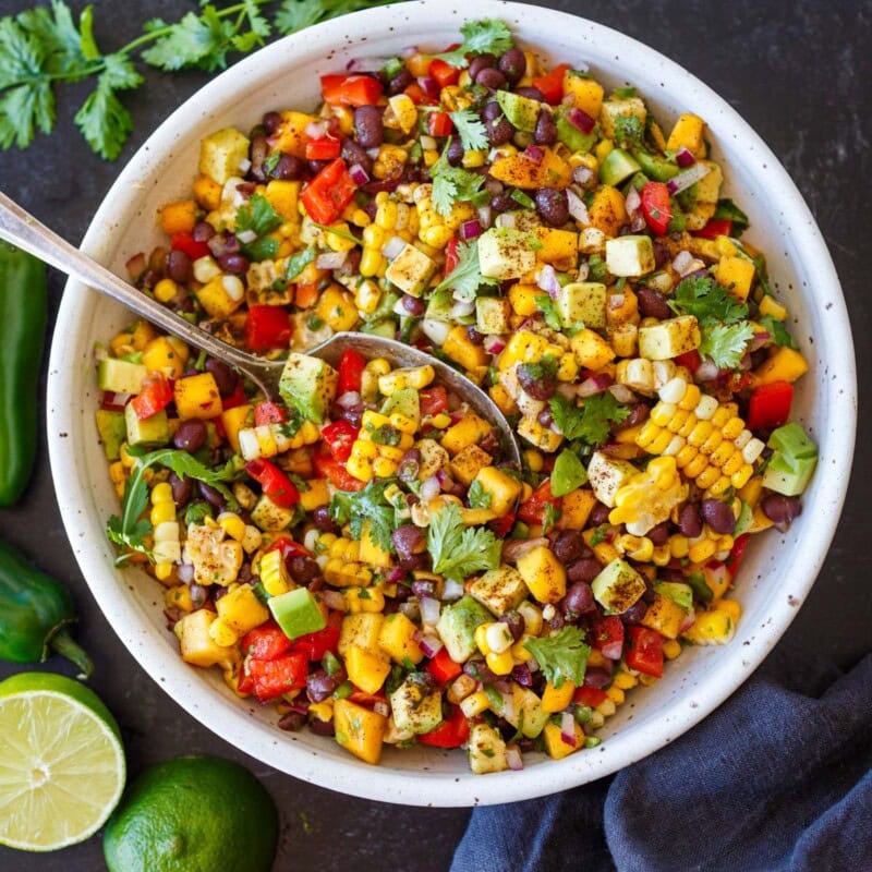 The hardest part about this Black Bean Salad is not eating it straight from the bowl. Sweet mango, creamy avocado, fresh corn, and a zesty lime dressing make every bite taste like summer. Ready in under 30 minutes, a healthy, protein-packed salad for meal prep, potlucks, and easy summer meals.
