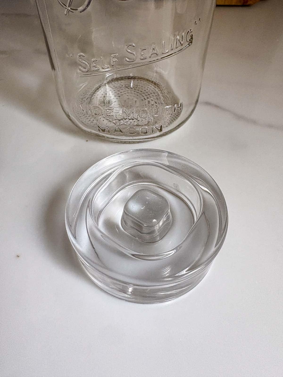 This is a glass fermentation weight use to help things below the brine level. 
