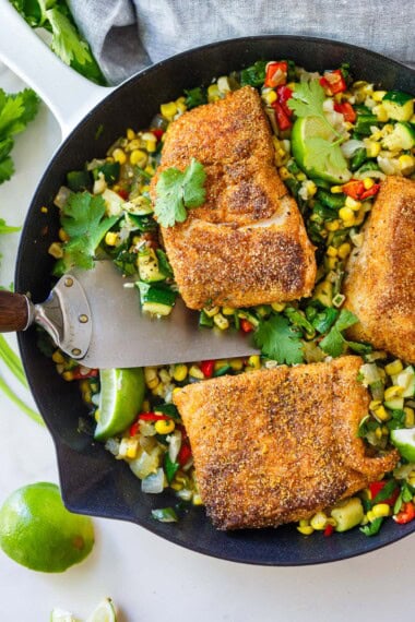 This Cornmeal-Crusted Halibut is crispy and golden, served over a vibrant summer succotash with sweet corn, zucchini, peppers, lime, and cilantro. An easy one-pan dinner, ready in 40 minutes.