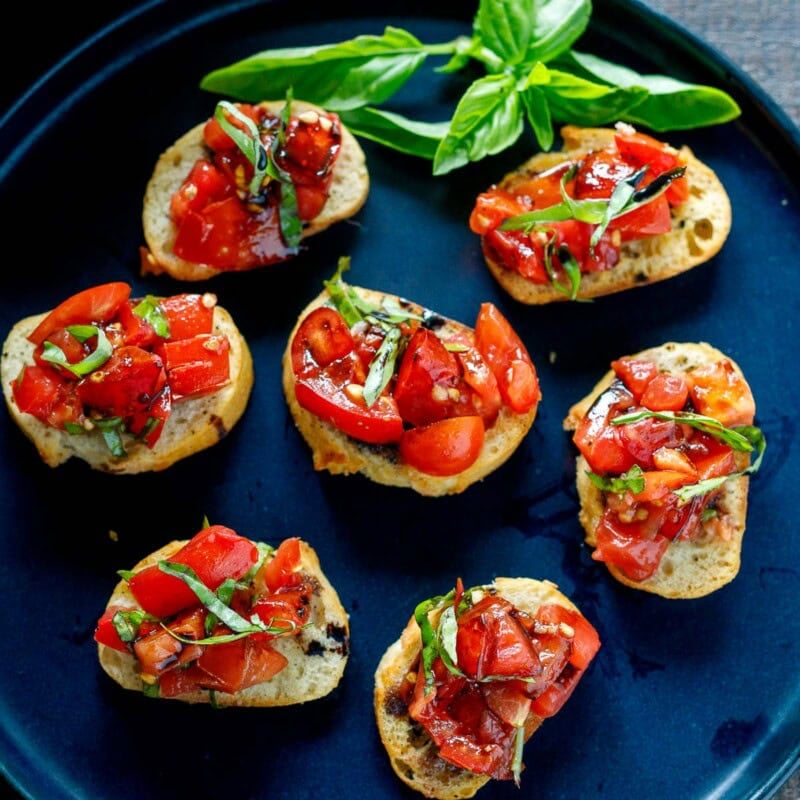 This classic Tomato Bruschetta is summer at its best-juicy ripe tomatoes, fresh basil, and crisp toasted bread rubbed with garlic for incredible flavor.