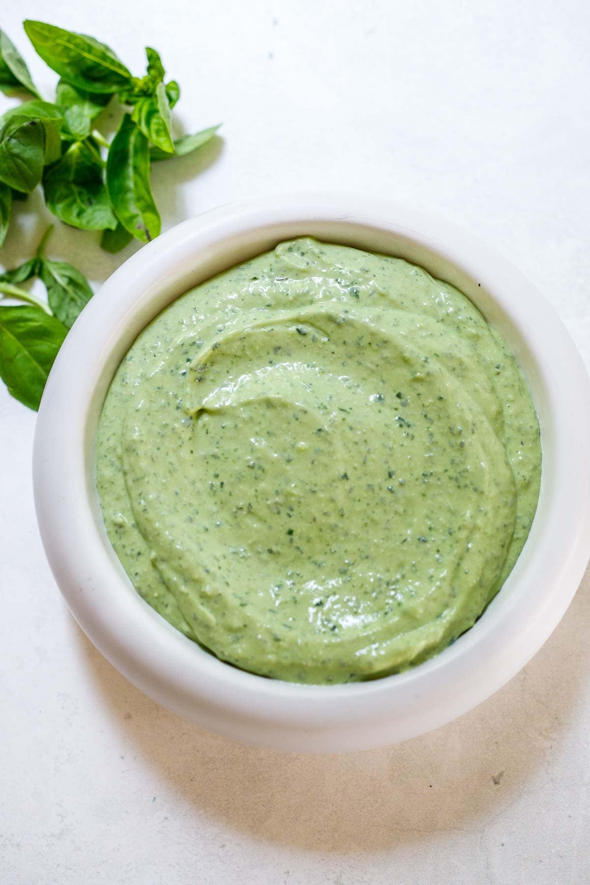 green whipped cottage cheese dip in a white bowl.