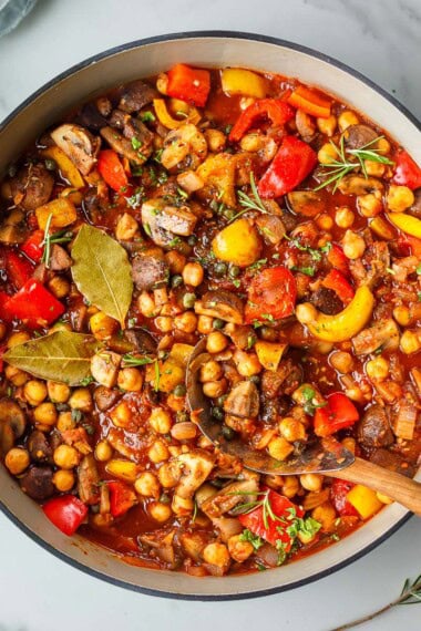 This cozy Chickpea Cacciatore is a hearty vegetarian dinner with tender chickpeas and “meaty” mushrooms simmered in a rich, rustic tomato sauce with rosemary, red wine, and briny capers. Vegan-adaptable!