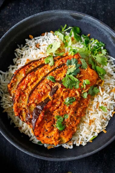 This Baked Eggplant Tikka Masala features tender, fan-roasted eggplant slathered in a rich, fragrant tikka masala sauce, baked until bubbling and golden. A cozy fall meal that is vegan-adaptable.
