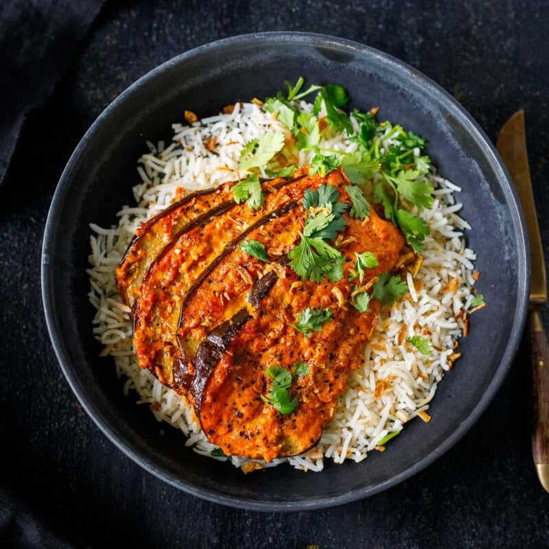 This Baked Eggplant Tikka Masala features tender, fan-roasted eggplant slathered in a rich, fragrant tikka masala sauce, baked until bubbling and golden. A cozy fall meal that is vegan-adaptable.