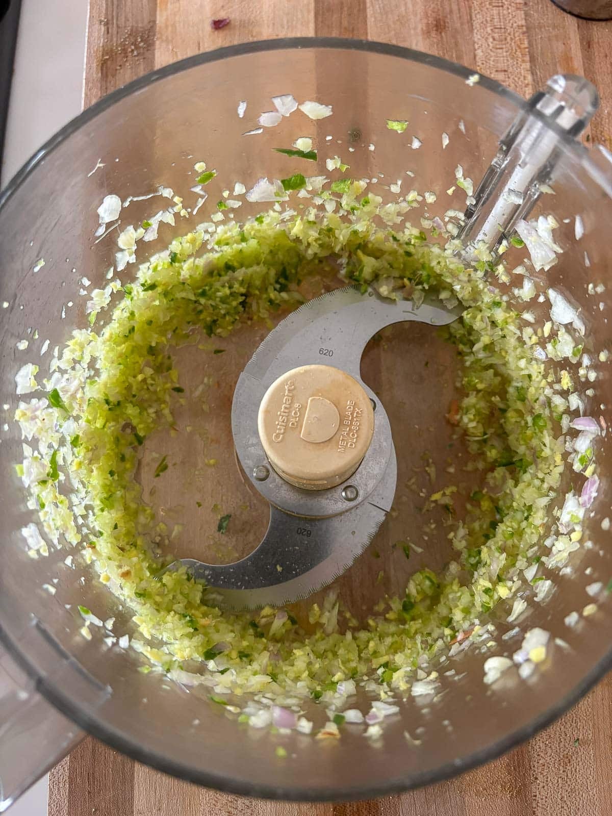 garlic, shallot, ginger, and serrano finely chopped in a food processor.