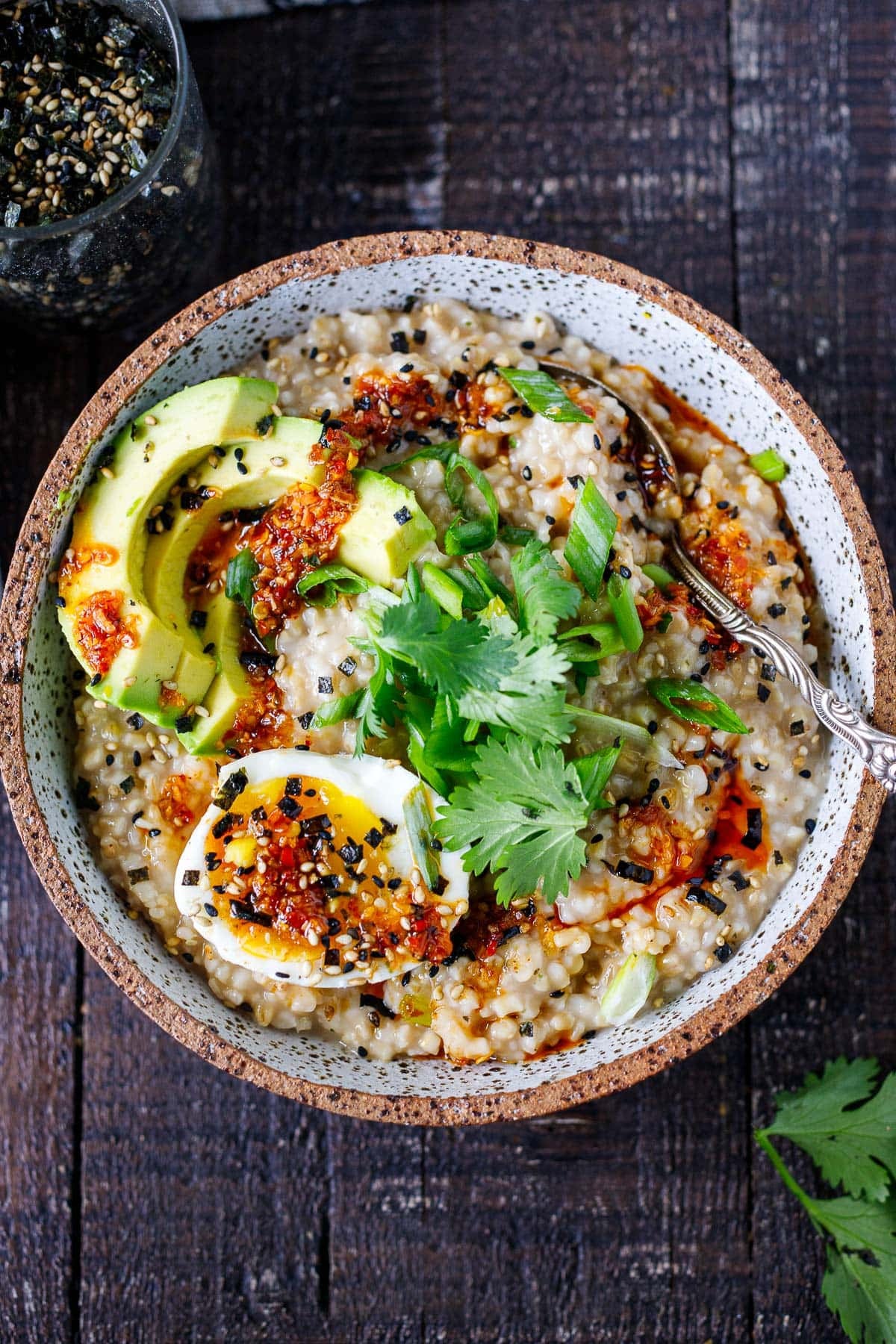 Savory oatmeal made with creamy steel-cut oats, mushrooms, avocado, jammy eggs, chili crisp, and furikake. A cozy, satisfying breakfast that's great for meal prep.