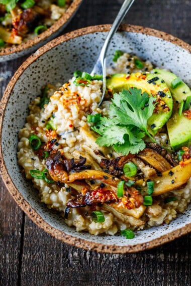Savory oatmeal made with creamy steel-cut oats, mushrooms, avocado, jammy eggs, chili crisp, and furikake. A cozy, satisfying breakfast that's great for meal prep.