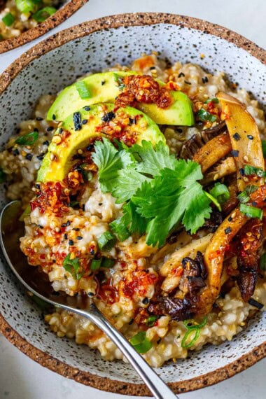 These savory steel-cut oats are creamy, comforting, and full of umami flavor. Top with sautéed mushrooms, avocado, jammy eggs, chili crisp, and furikake for a satisfying breakfast that's perfect for meal prep.