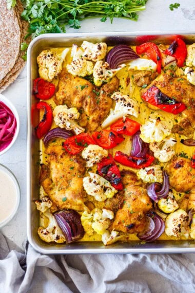 Baked chicken shawarma on a sheet pan with vegetables