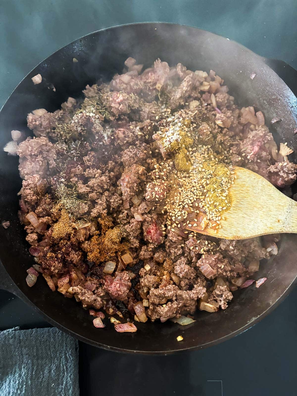 Adding the zaatar spice and seasoning with salt and pepper